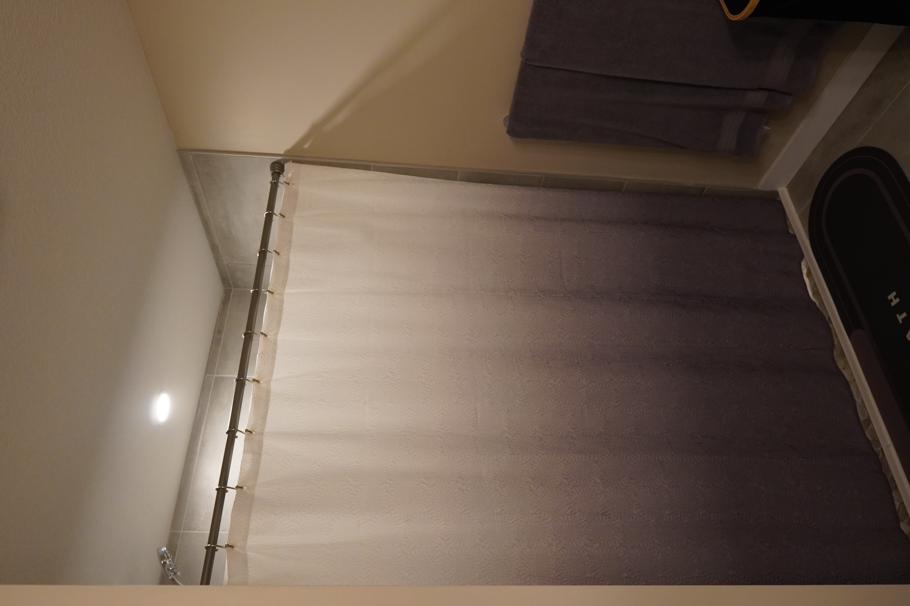 Symmetrical kitchen layout with white cabinets, globe chandelier, and organized counter space